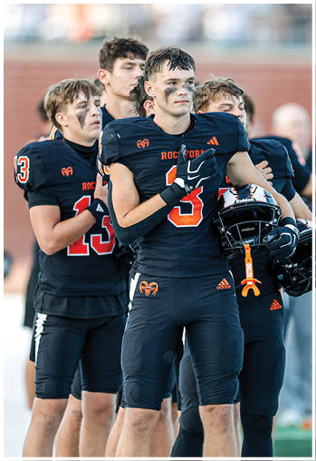A group of football players celebrating a touchdown. Description generated by AI