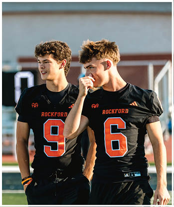 A group of football players celebrating a touchdown. Description generated by AI