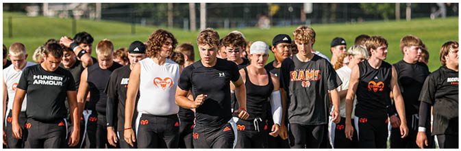 A group of football players on a field. Description generated by AI