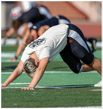A group of football players celebrating a touchdown. Description generated by AI