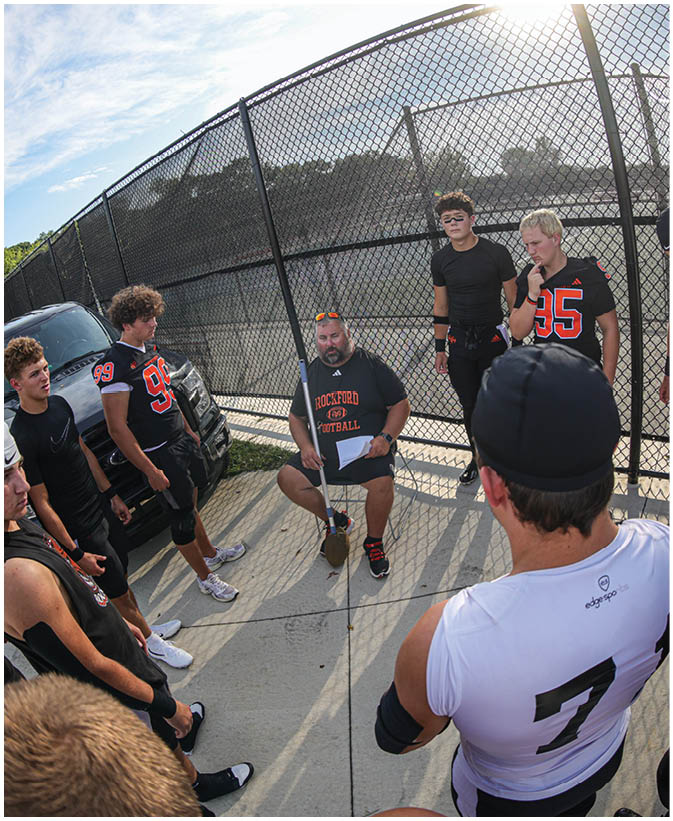A group of football players on a field. Description generated by AI