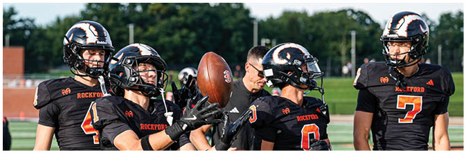 A group of football players on a field. Description generated by AI
