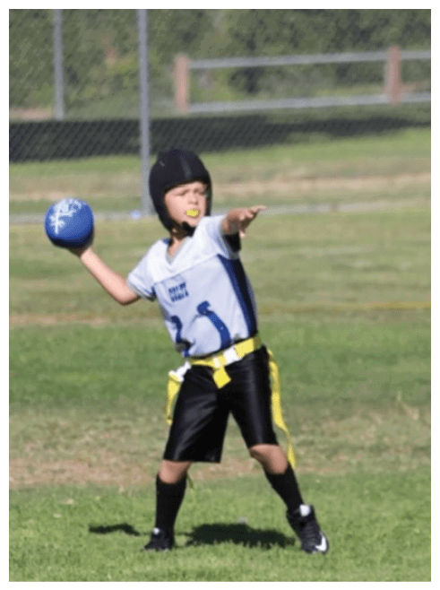 Two football players wearing black jerseys and holding hands. Description generated by AI