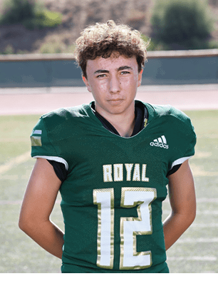 A young man wearing a white and black jersey with the number 14 on it. Description generated by AI