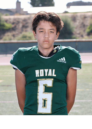 A young man wearing a white and black jersey with the number 14 on it. Description generated by AI