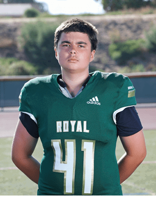 A young man wearing a white and black jersey with the number 14 on it. Description generated by AI