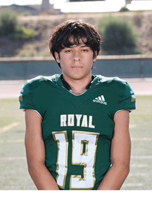 A young man wearing a white and black jersey with the number 14 on it. Description generated by AI