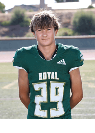 A young man wearing a white and black jersey with the number 14 on it. Description generated by AI