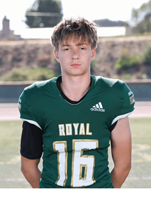 A young man wearing a white and black jersey with the number 14 on it. Description generated by AI