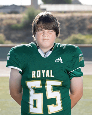 A young man wearing a white and black jersey with the number 14 on it. Description generated by AI