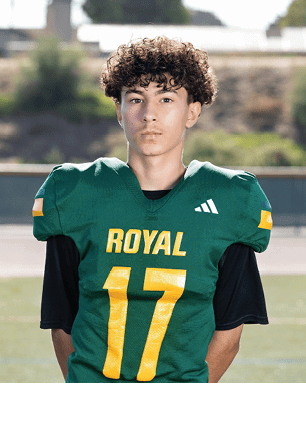 A young man wearing a white and black jersey with the number 14 on it. Description generated by AI