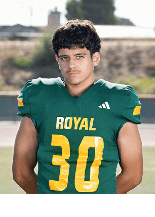 A young man wearing a white and black jersey with the number 14 on it. Description generated by AI