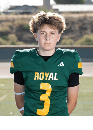 A young man wearing a white and black jersey with the number 14 on it. Description generated by AI