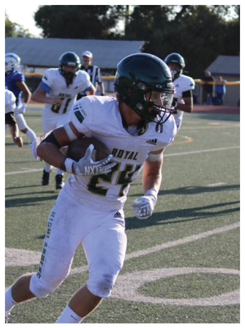 Two football players wearing black jerseys and holding hands. Description generated by AI