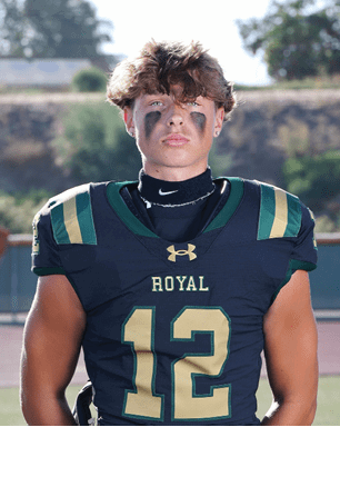 A young man wearing a white and black jersey with the number 14 on it. Description generated by AI