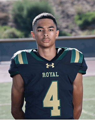 A young man wearing a white and black jersey with the number 14 on it. Description generated by AI