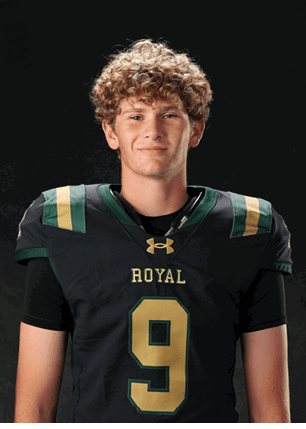 A young man wearing a white and black jersey with the number 14 on it. Description generated by AI