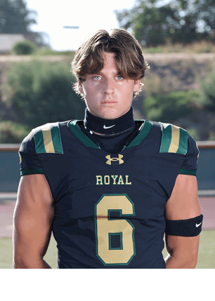 A young man wearing a white and black jersey with the number 14 on it. Description generated by AI