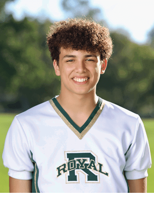 A young man wearing a white and black jersey with the number 14 on it. Description generated by AI