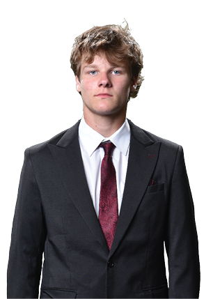 A young man wearing a white and black jersey with the number 14 on it. Description generated by AI
