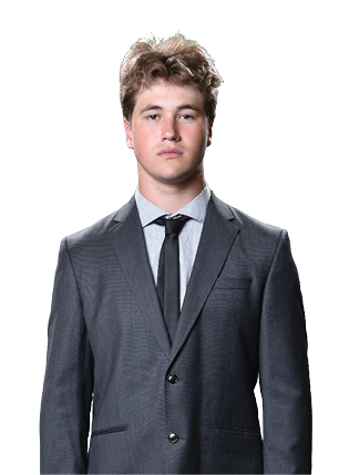 A young man wearing a white and black jersey with the number 14 on it. Description generated by AI