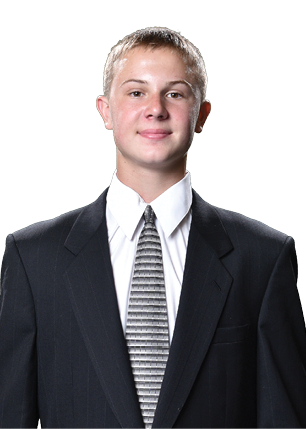 A young man wearing a white and black jersey with the number 14 on it. Description generated by AI