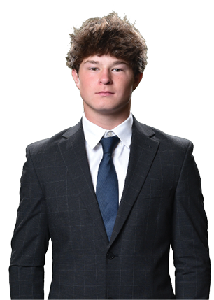 A young man wearing a white and black jersey with the number 14 on it. Description generated by AI