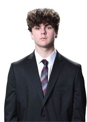 A young man wearing a white and black jersey with the number 14 on it. Description generated by AI
