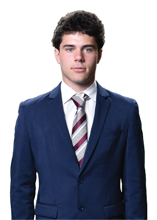A young man wearing a white and black jersey with the number 14 on it. Description generated by AI