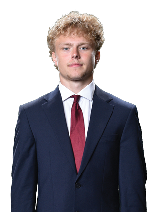 A young man wearing a white and black jersey with the number 14 on it. Description generated by AI