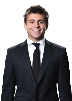 A young man wearing a white and black jersey with the number 14 on it. Description generated by AI
