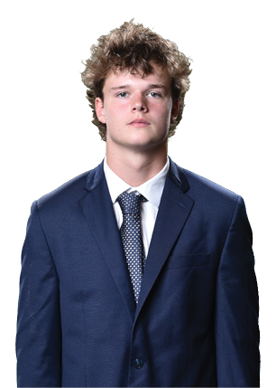 A young man wearing a white and black jersey with the number 14 on it. Description generated by AI