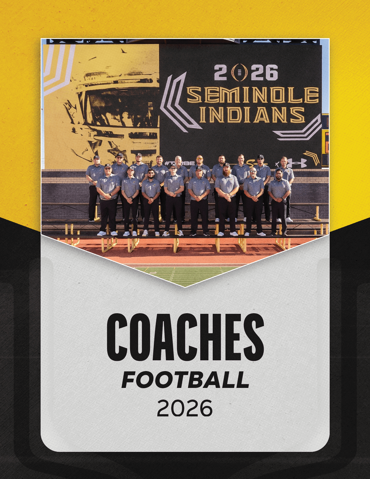 A group of adults wearing matching shirts stand in front of a large scoreboard displaying the text “2026 Seminole Indians" with a football helmet graphic above the words "Coaches Football 2026" on a yellow and black background. Description generated by AI