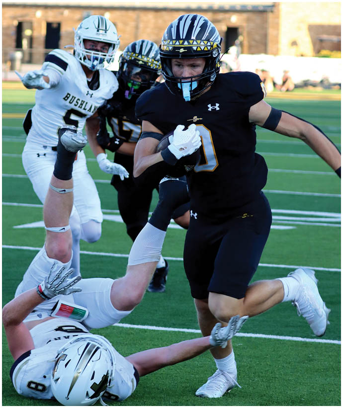A group of football players wearing black and white uniforms. Description generated by AI