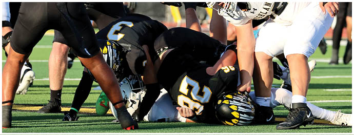 A football player is sliding on the ground. Description generated by AI