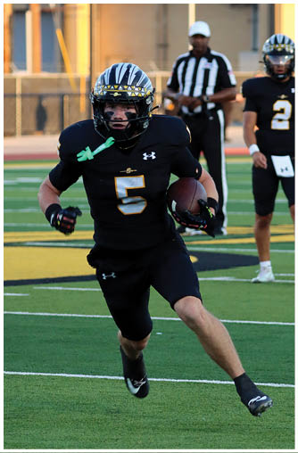 A football player running on the field. Description generated by AI