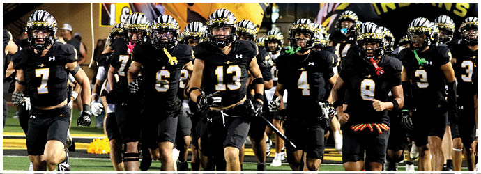 A group of football players on a field. Description generated by AI