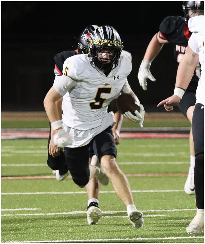 A group of football players wearing black and white uniforms. Description generated by AI