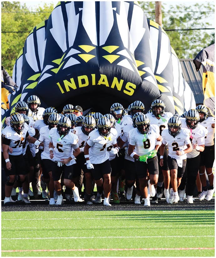 A group of football players wearing black and white uniforms. Description generated by AI