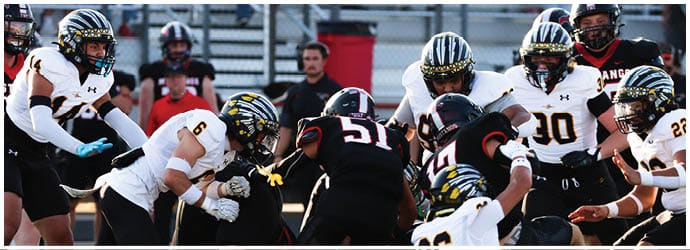 A group of football players on a field. Description generated by AI