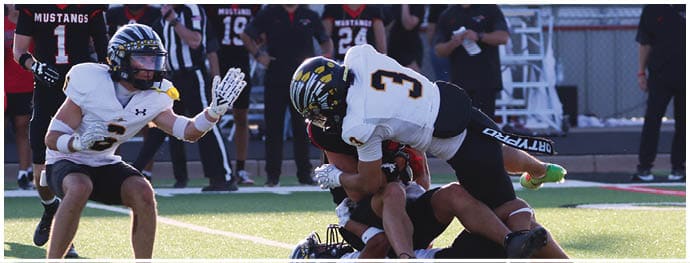 A football player is sliding on the ground. Description generated by AI