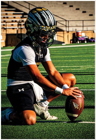 A football player wearing a blue and white uniform. Description generated by AI