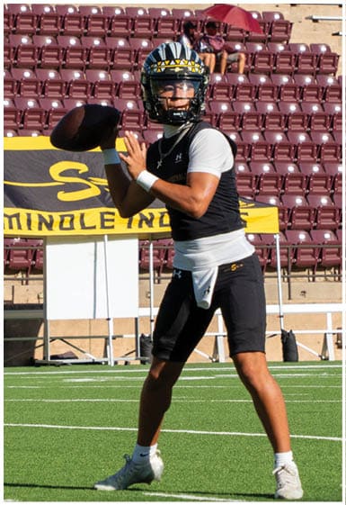 A football player wearing a blue and white uniform. Description generated by AI