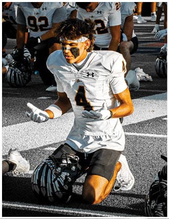A football player running on the field. Description generated by AI