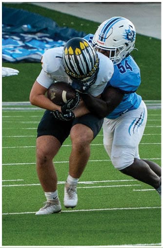 A football player running on the field. Description generated by AI