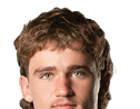 Person with curly hair and light eyes looking forward against a white background. Description generated by AI