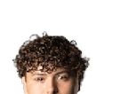 Person with curly hair and light eyes looking forward against a white background. Description generated by AI
