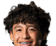Person with curly hair and light eyes looking forward against a white background. Description generated by AI