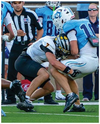 A football player running on the field. Description generated by AI
