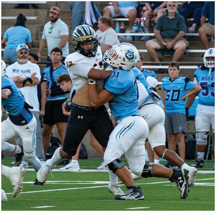 A group of football players wearing black and white uniforms. Description generated by AI